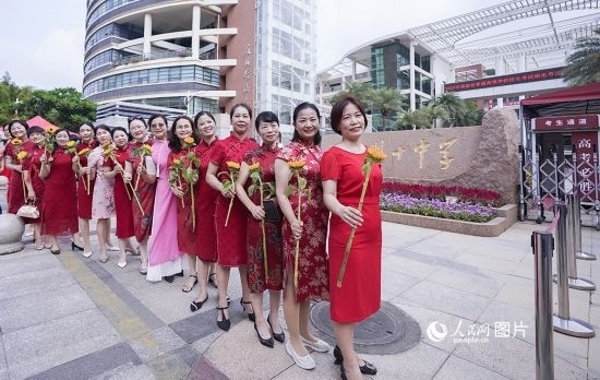 6月7日一早，廈門雙十中學(xué)考生家長們身穿旗袍，手拿向日葵在考場外為孩子加油打氣，寓意“旗開得勝，一舉奪魁”。人民網(wǎng)記者 陳博攝