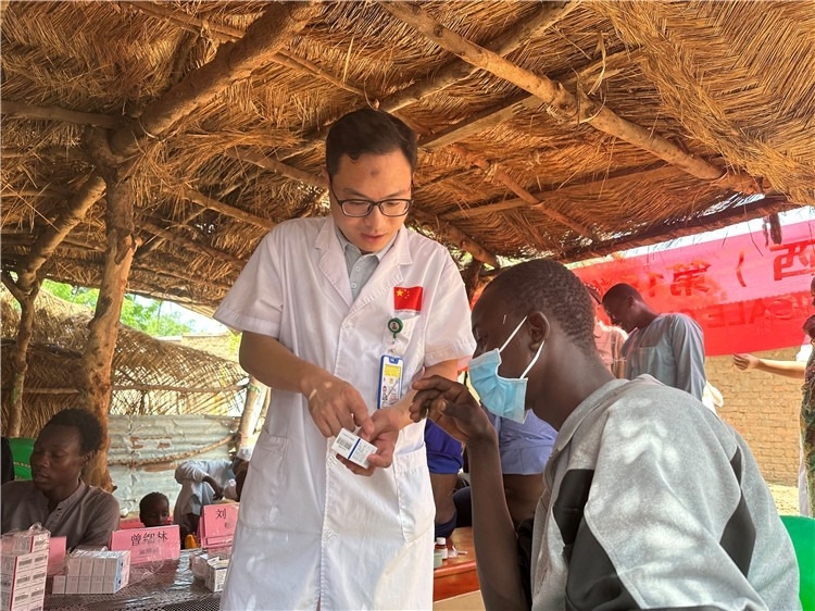 圖為南昌大學(xué)第一附屬醫(yī)院病理科主治醫(yī)師張振東為村民解說藥品使用方法。中國駐乍得醫(yī)療隊(duì)供圖