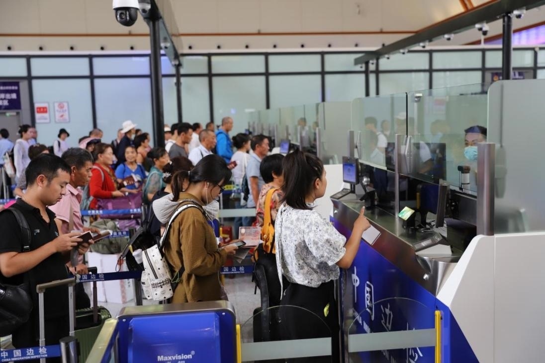 出境旅客在辦理通關(guān)手續(xù)。人民網(wǎng)記者 李發(fā)興攝