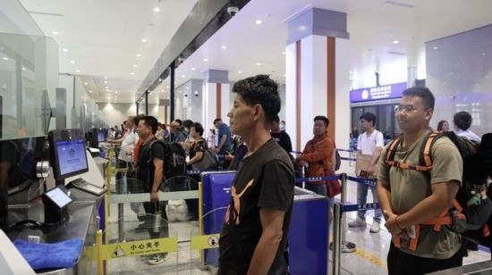 6月13日，乘坐中老鐵路國(guó)際旅客列車的旅客在磨憨邊檢大廳排隊(duì)候檢。李揚(yáng) 攝