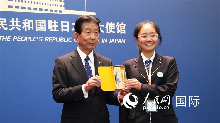 中國小大使向日本永旺1%俱樂部理事長森美樹贈送當地特色禮品。人民網 許可攝