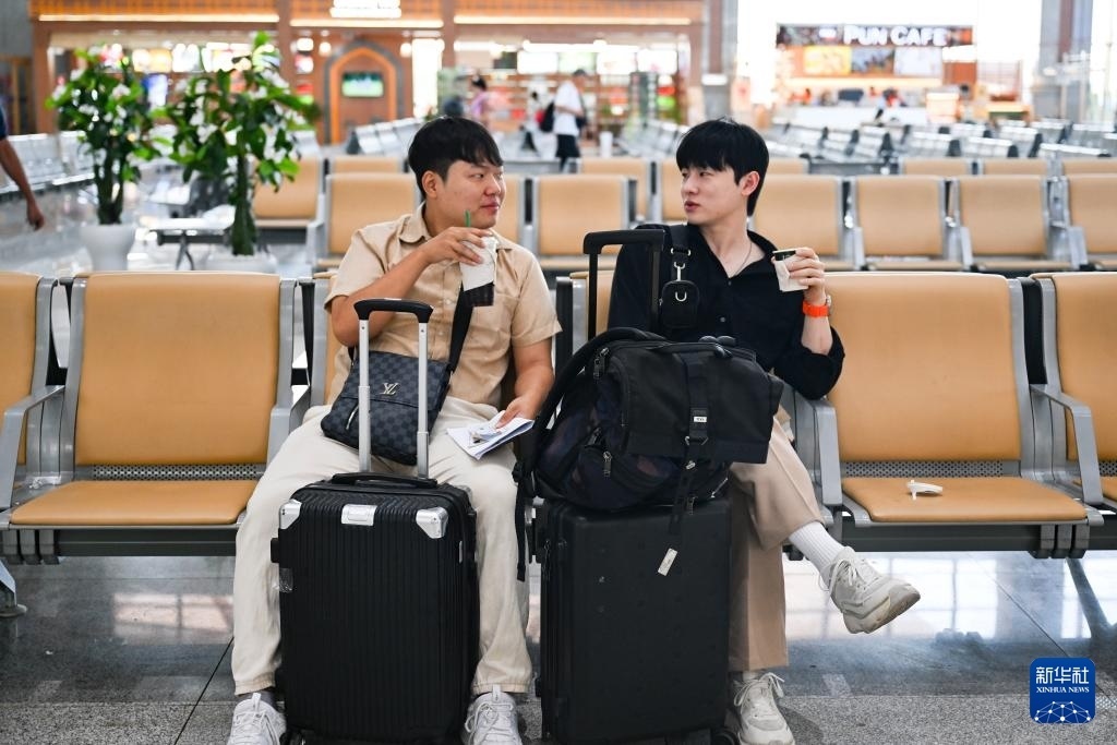 10月12日，在老撾萬(wàn)象中老鐵路萬(wàn)象站候車廳，兩名乘客在等候列車。新華社記者 程一恒 攝