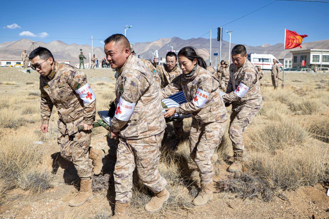 1月9日，日喀則定日縣長所鄉(xiāng)，西藏軍區(qū)總醫(yī)院醫(yī)療隊(duì)隊(duì)員將受傷村民用擔(dān)架從救護(hù)車準(zhǔn)備抬上直升機(jī)，轉(zhuǎn)運(yùn)至拉薩的西藏軍區(qū)總醫(yī)院救治。人民日?qǐng)?bào)記者張武軍攝
